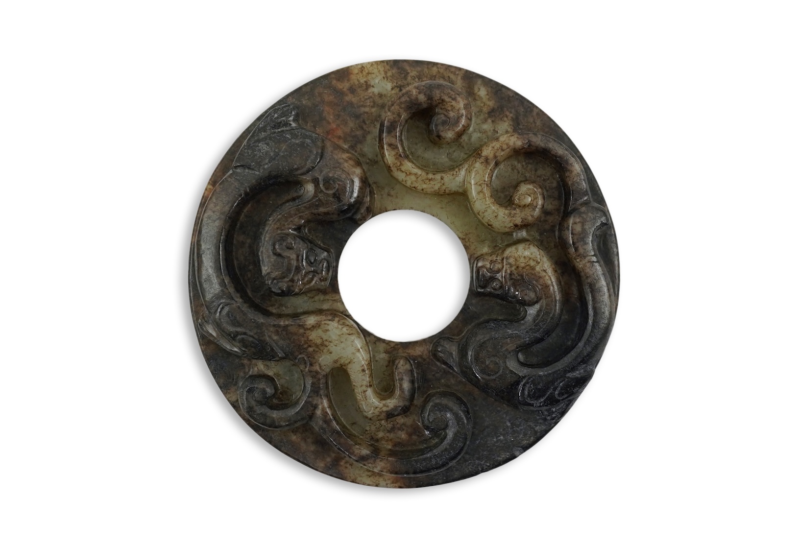 A Chinese pale celadon and black jade bi disc